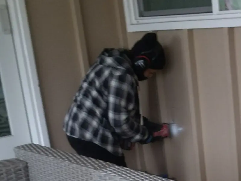 Professional electrician installing an exterior outlet in Andover